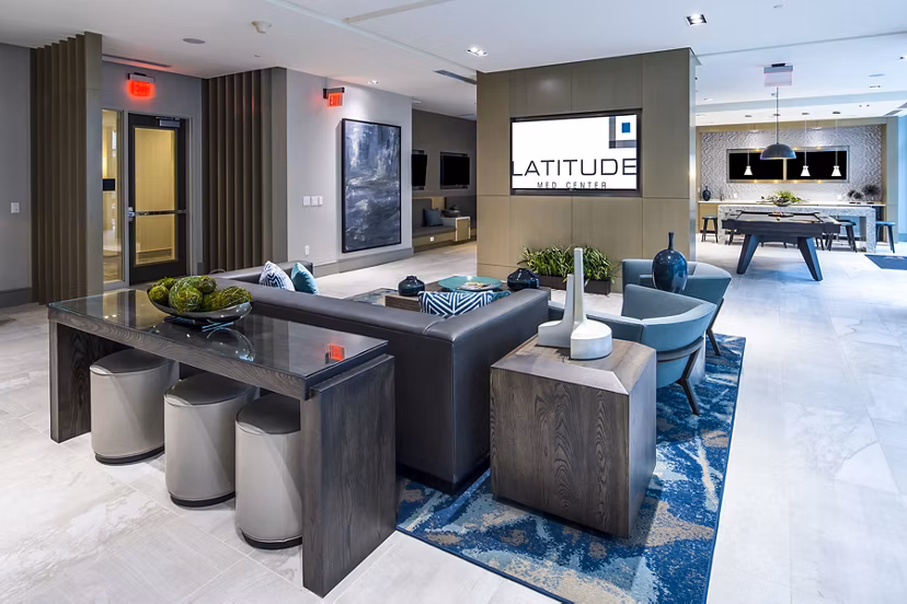 Game room with pool table and lounge seating at Latitude Med Center Apartments, a luxury living community in Houston