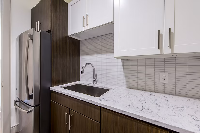 Modern kitchen with stainless steel appliances at Latitude Med Center Apartments