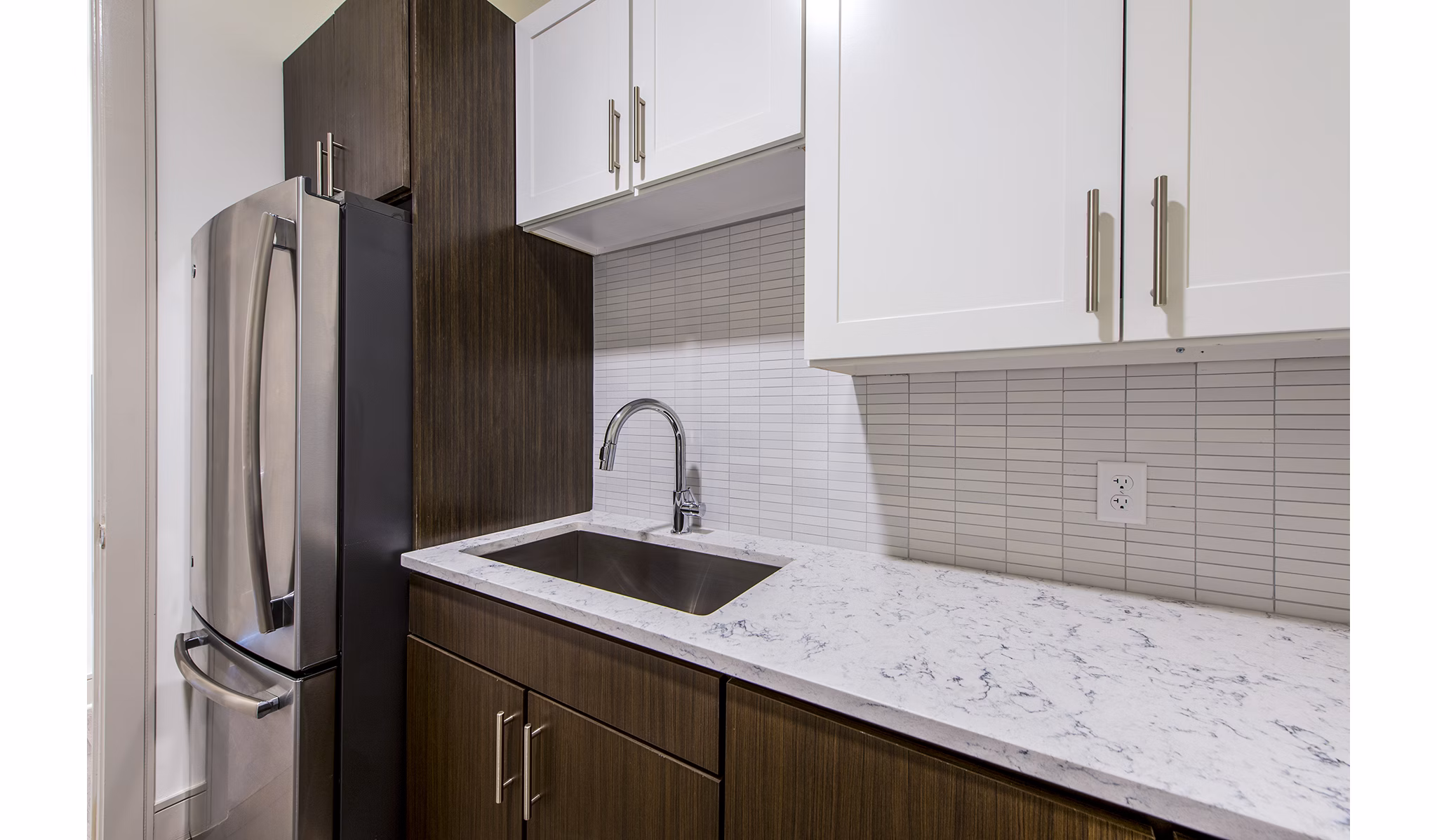 Modern kitchen with stainless steel appliances at Latitude Med Center Apartments