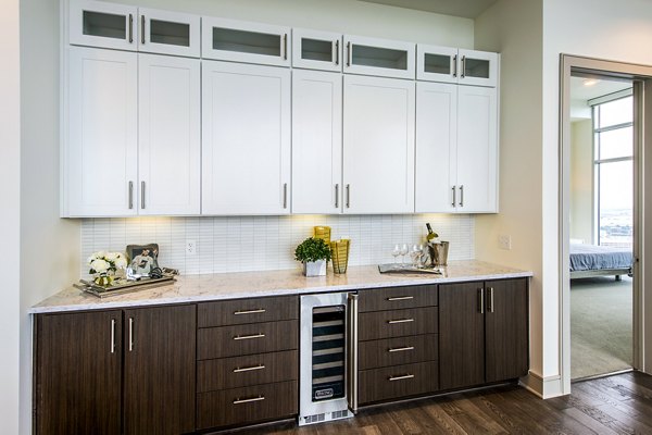 Dining room with cocktail bar at Latitude Med Center Apartments, featuring modern dÃ©cor and elegant lighting for luxury living