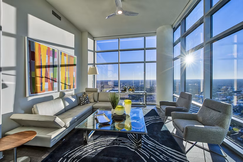 Living room with modern decor and large windows at Latitude Med Center Apartments, luxury living in an upscale Houston neighborhood