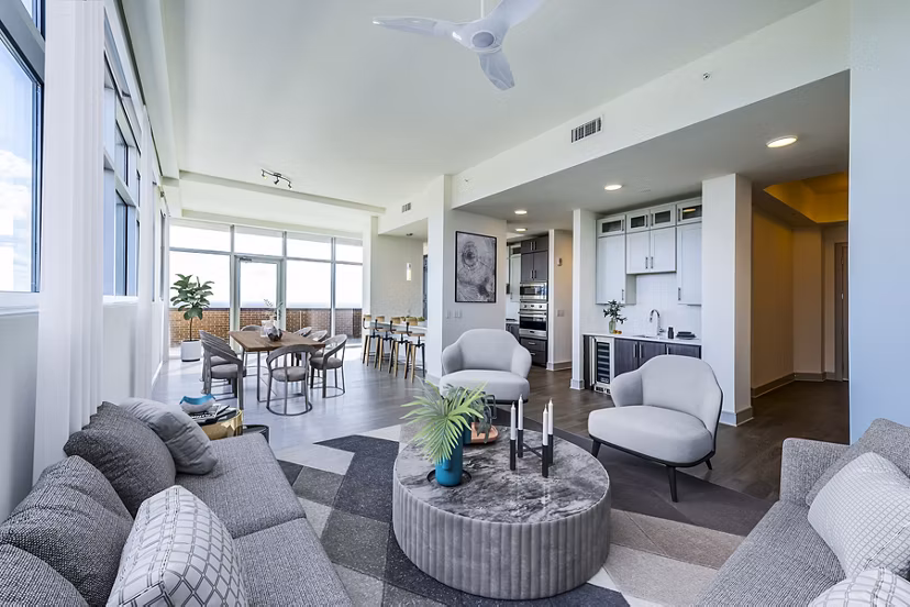 Living room with modern furnishings and city views at Latitude Med Center Apartments