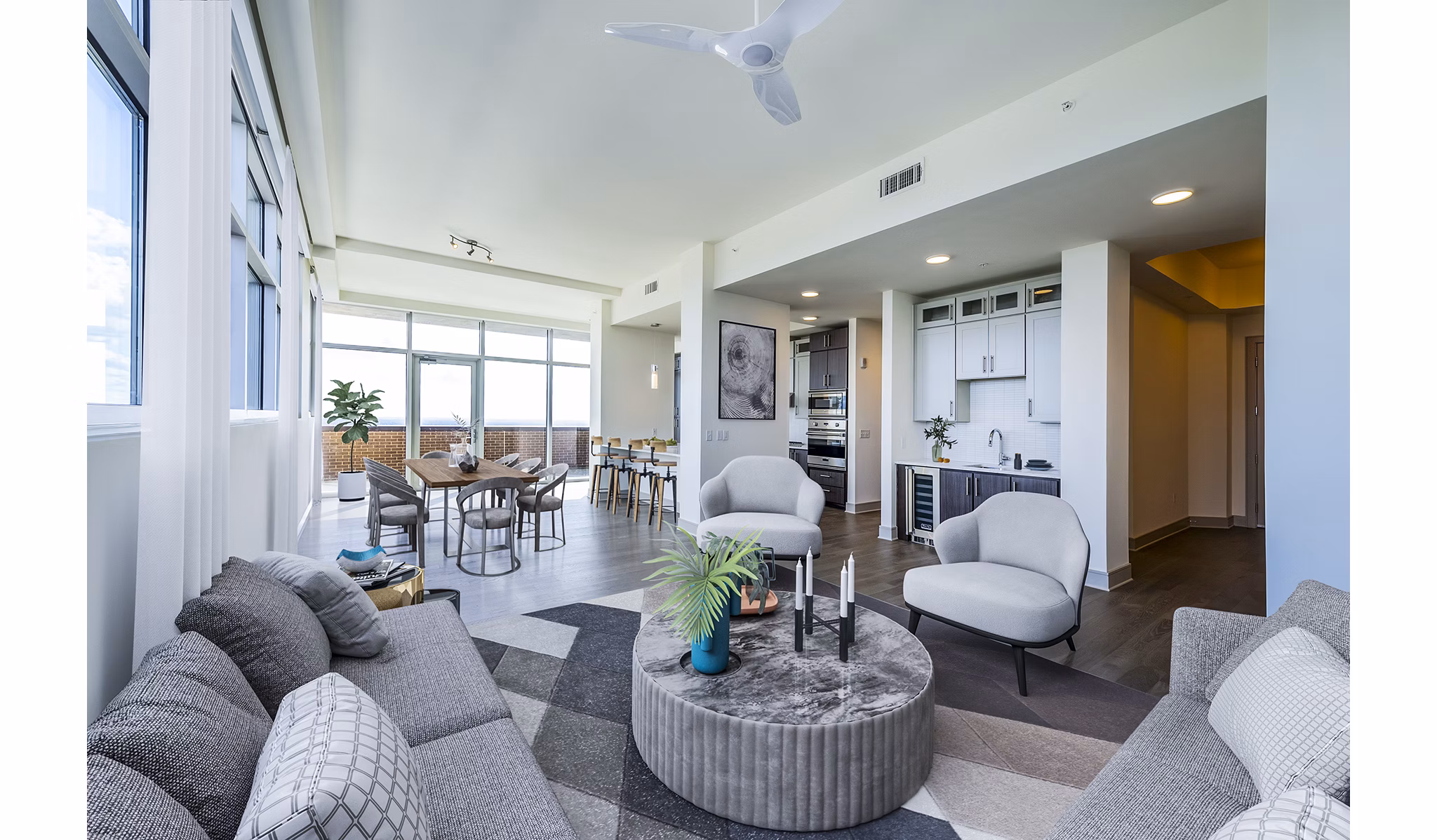 Living room with modern furnishings and city views at Latitude Med Center Apartments