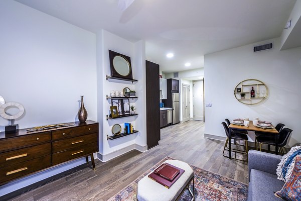 Modern living room with sleek furnishings and large windows at Latitude Med Center Apartments in Houston