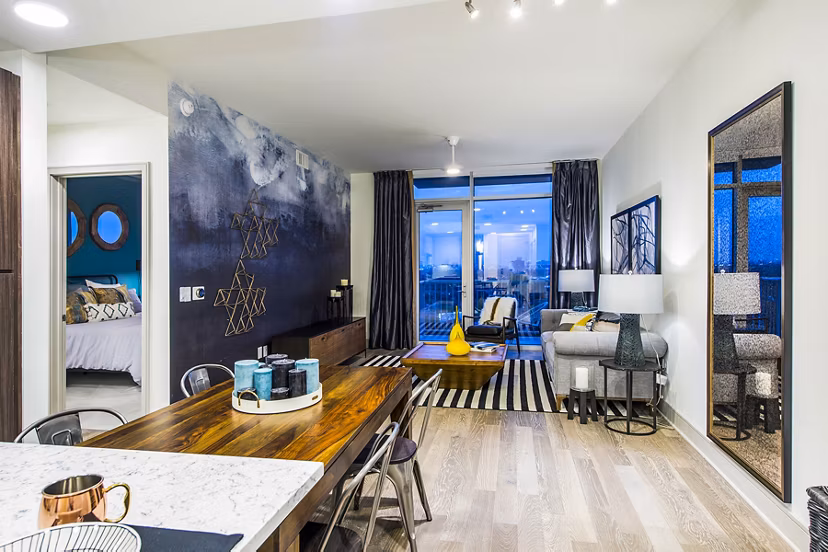 Modern living room with stylish decor and large windows at Latitude Med Center Apartments