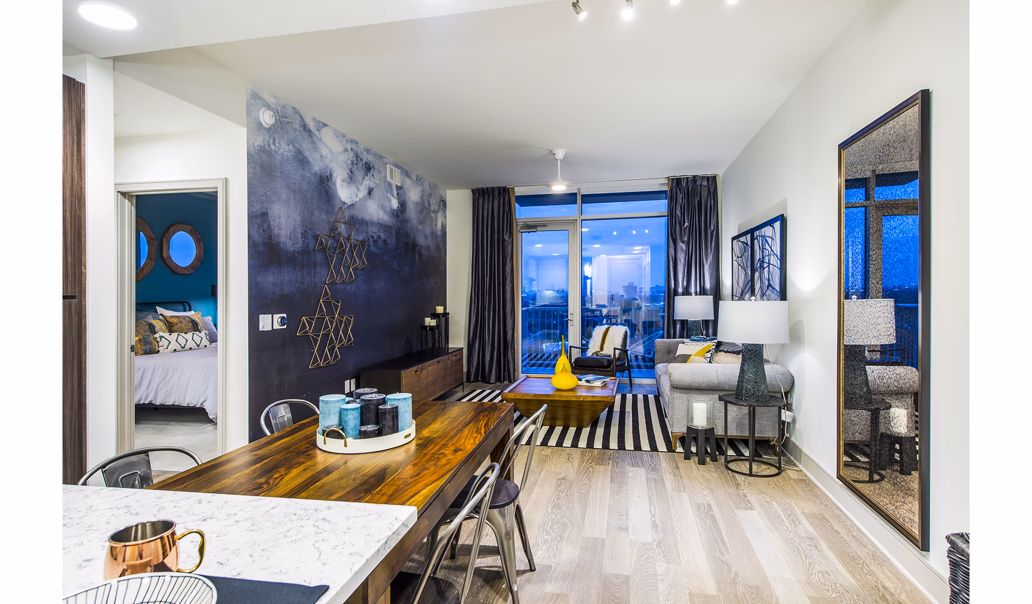 Modern living room with stylish decor and large windows at Latitude Med Center Apartments
