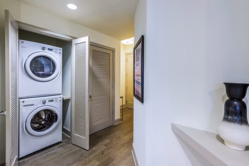 Laundry room with modern washers and dryers at Latitude Med Center Apartments in Houston