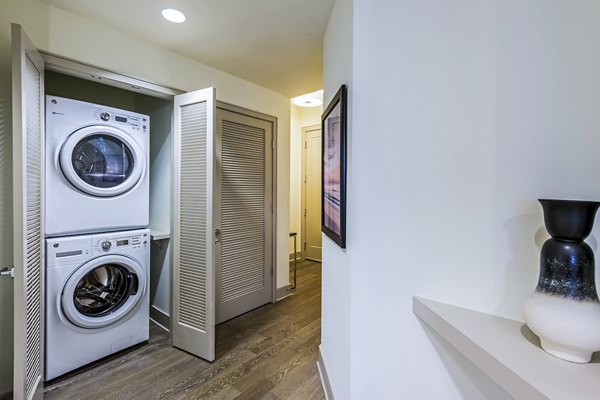 Laundry room with modern washers and dryers at Latitude Med Center Apartments in Houston