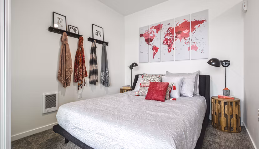 Bedroom featuring stylish design and large windows at Zig Apartments