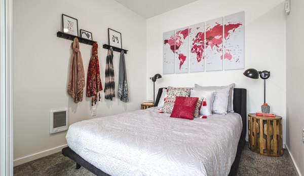 Bedroom featuring stylish design and large windows at Zig Apartments