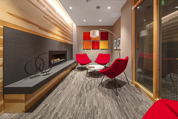 Modern clubhouse with stylish seating and entertainment area at Zig Apartments, ideal for social gatherings and relaxation