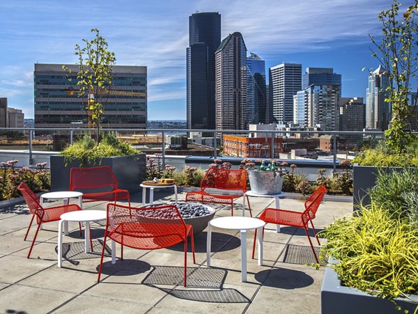 Modern rooftop patio with skyline views at Zig Apartments, featuring comfortable seating and outdoor amenities