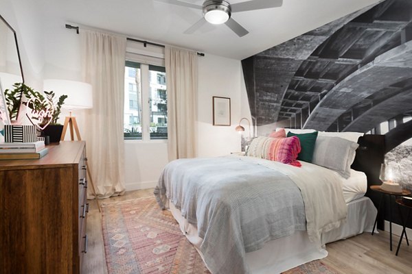 Cozy bedroom with modern decor and large windows at Avila Apartments in Greystar's luxury community