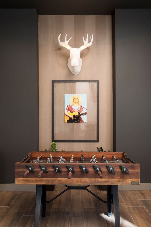 Game room featuring pool table and lounge seating at Avila Apartments