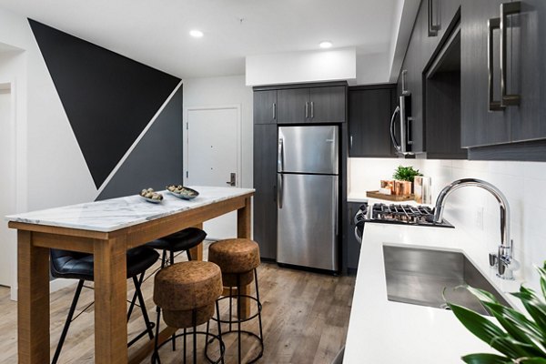 Modern kitchen with stainless steel appliances at Avila Apartments