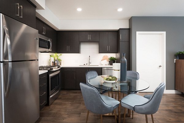 Modern kitchen with stainless steel appliances in Avila Apartments luxury community