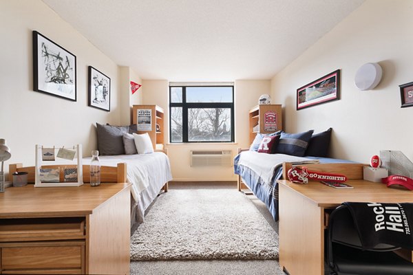 Cozy bedroom with modern decor including a queen bed and stylish furnishings at SoCam 290 Apartments, offering luxury living in a prime location
