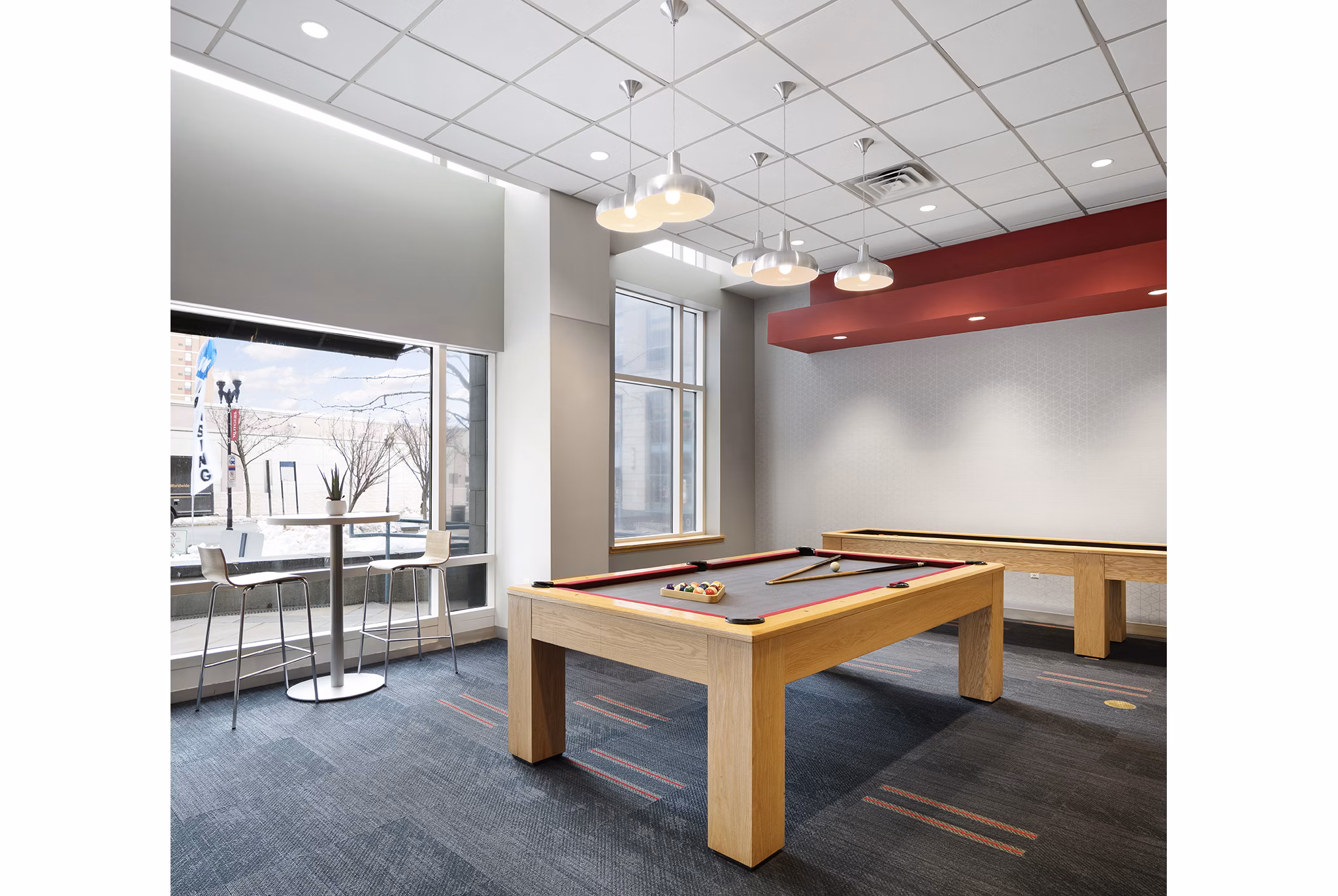 Clubhouse featuring modern decor and abundant seating at SoCam 290 Apartments in vibrant city setting