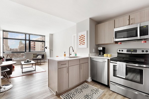 Modern kitchen with stainless steel appliances at SoCam 290 Apartments