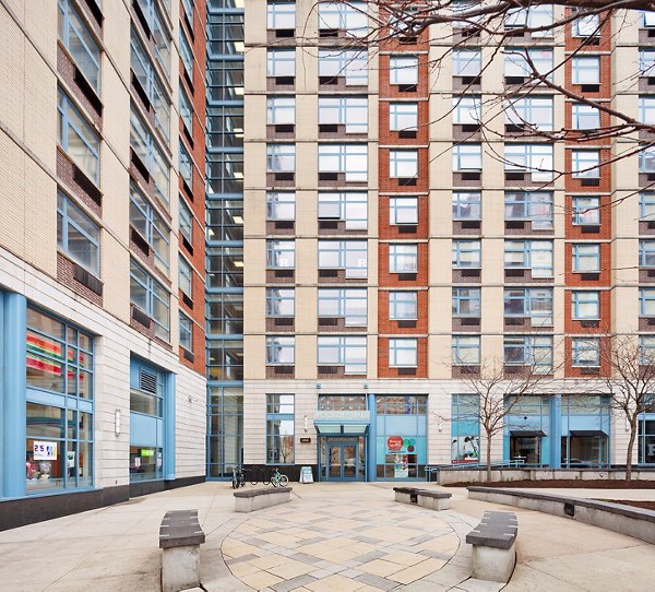 SoCam 290 Apartments: Modern courtyard with lush greenery and seating areas, perfect for relaxation and social gatherings