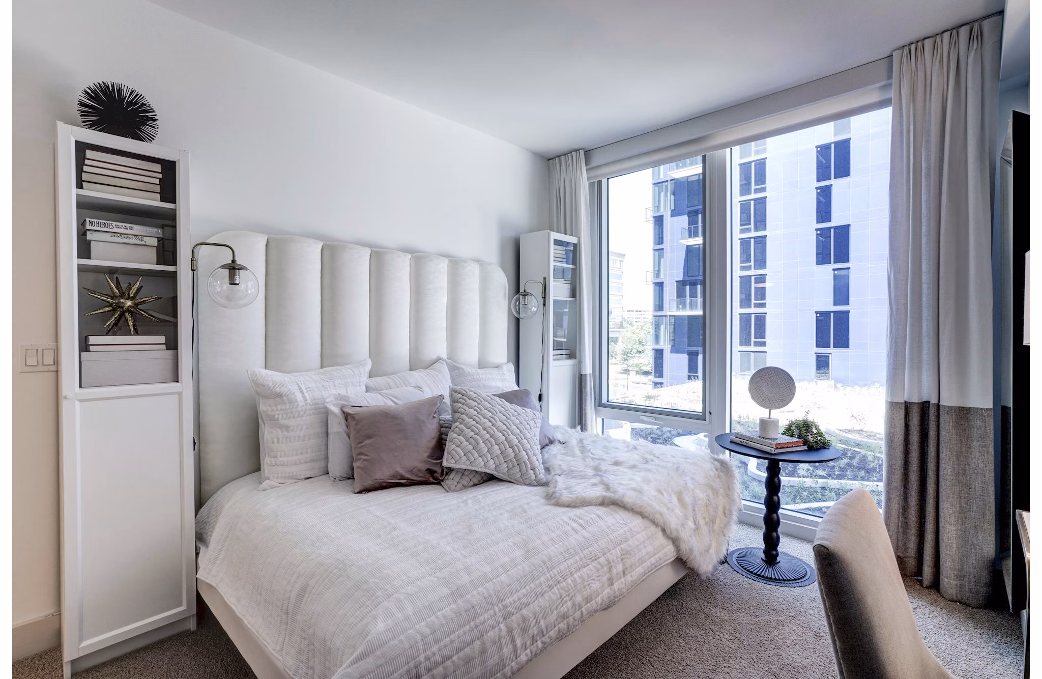 Cozy bedroom with modern decor in Exo Apartments luxury high-rise