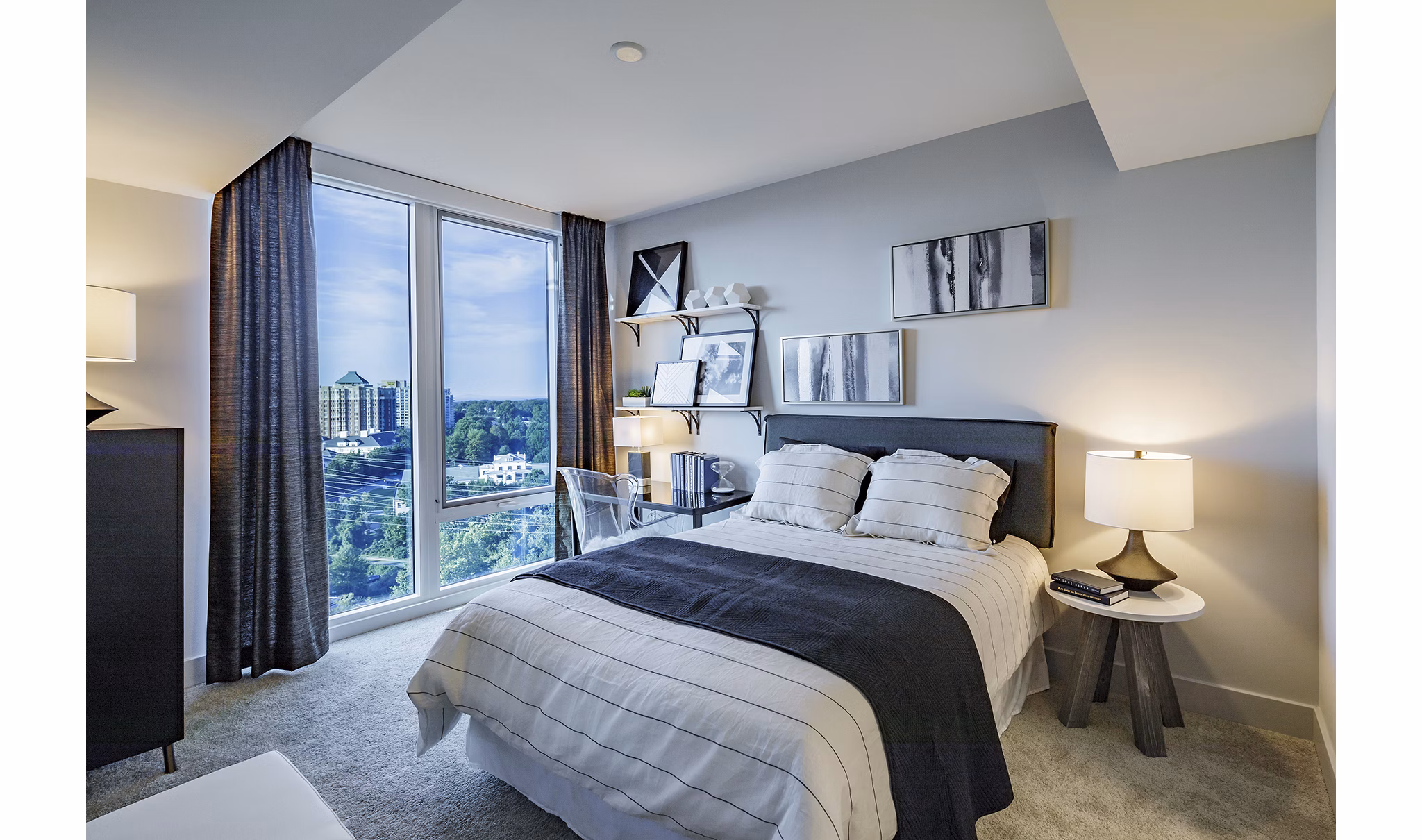 Cozy bedroom featuring modern design and natural lighting at Exo Apartments