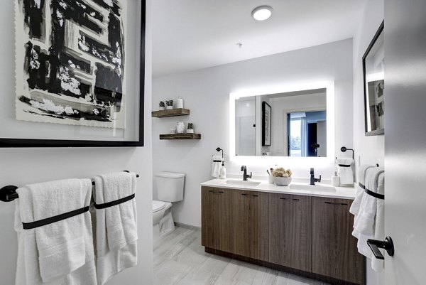 Bathroom featuring elegant fixtures and marble countertops in Exo Apartments, a Greystar luxury property