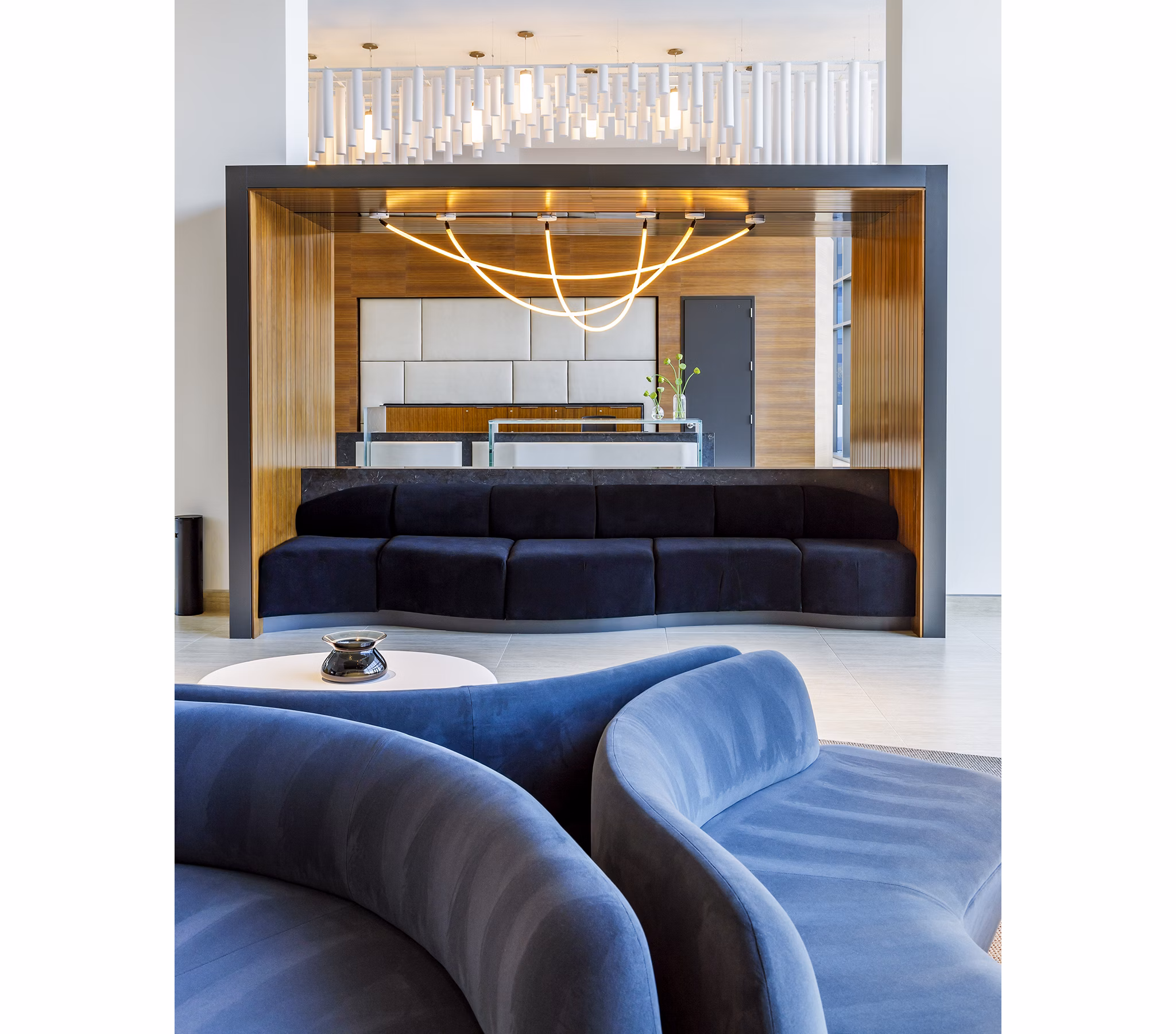 Modern clubhouse featuring plush seating and large TV at Exo Apartments, offering luxurious communal spaces for residents