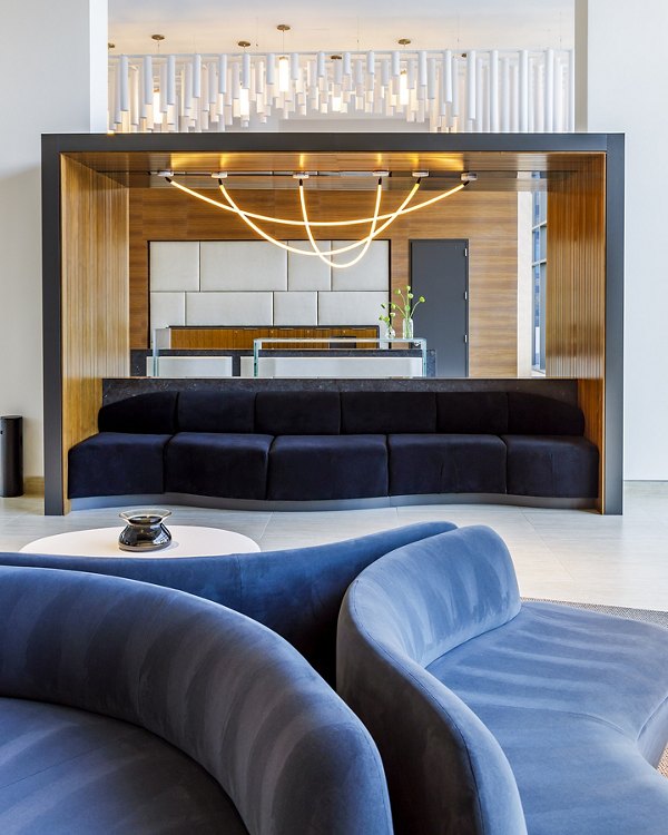 Modern clubhouse featuring plush seating and large TV at Exo Apartments, offering luxurious communal spaces for residents