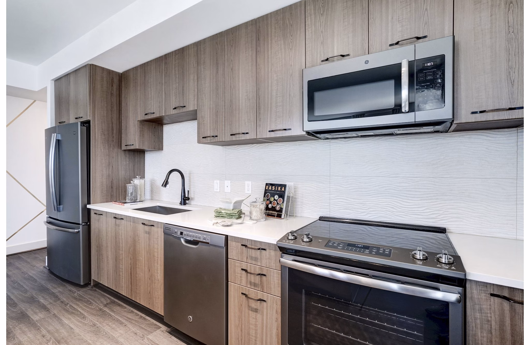Modern kitchen featuring stainless steel appliances in Exo Apartments luxury living