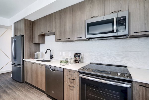 Modern kitchen featuring stainless steel appliances in Exo Apartments luxury living