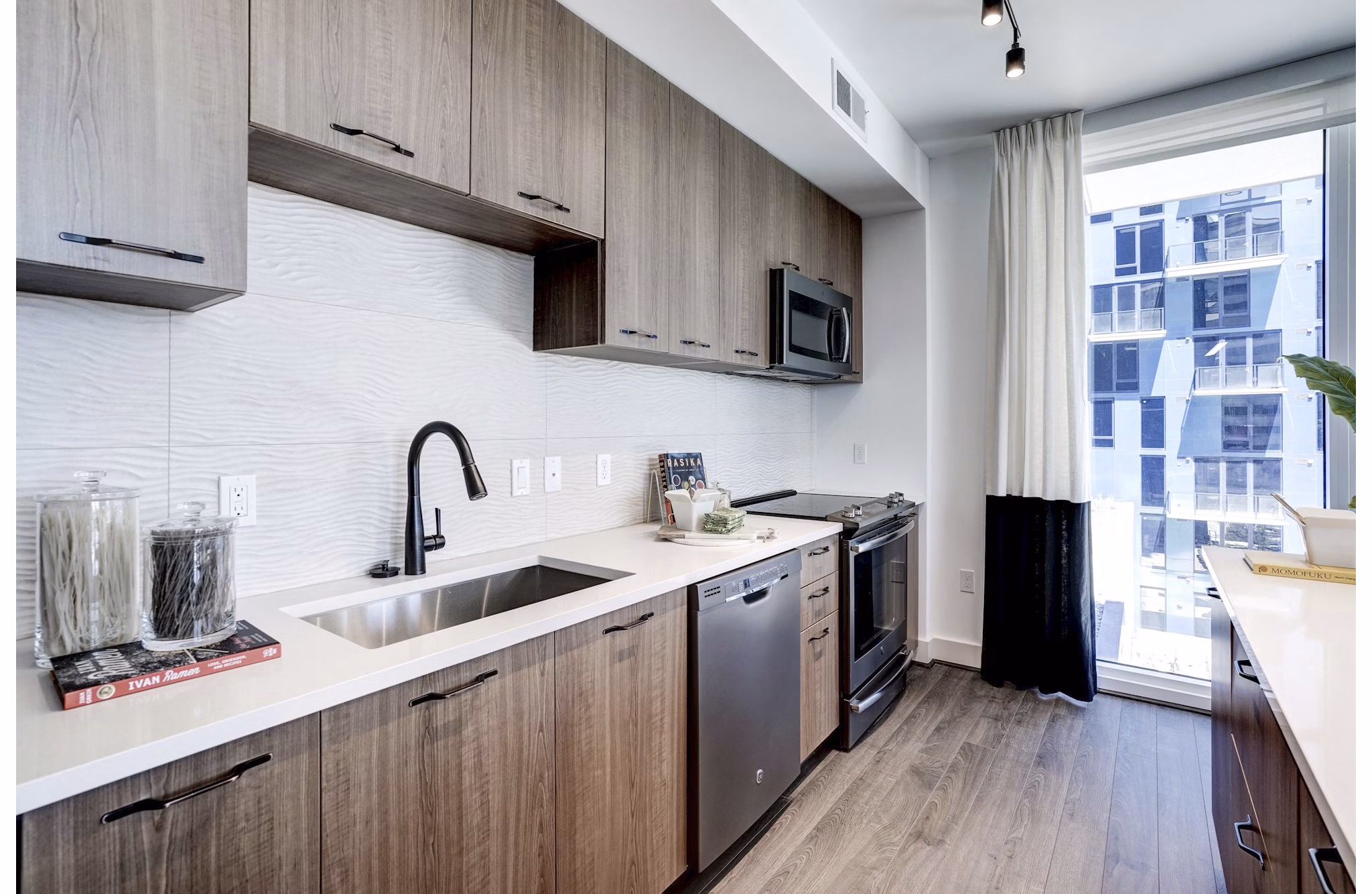 Modern kitchen with stainless steel appliances in Exo Apartments