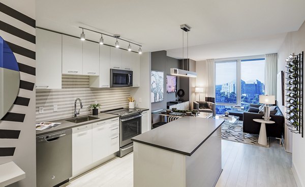 Modern kitchen with sleek countertops and stainless steel appliances at Exo Apartments