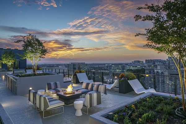Spacious patio with modern furnishings at Exo Apartments, offering scenic views for relaxation and leisure