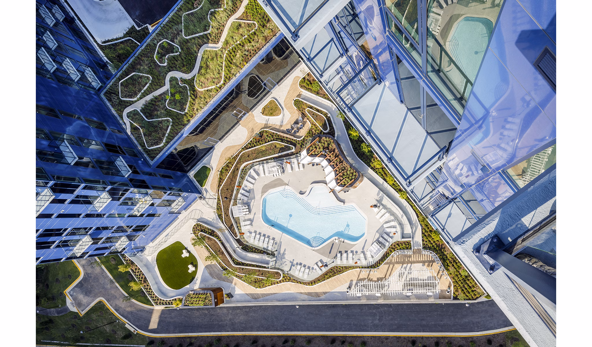 Inviting outdoor pool at Exo Apartments offering relaxation and recreation in a luxurious setting