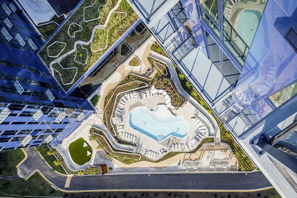 Inviting outdoor pool at Exo Apartments offering relaxation and recreation in a luxurious setting