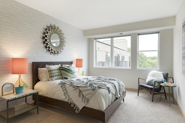 Spacious bedroom with modern decor and ample natural light at Ellipse on Excelsior luxury apartments