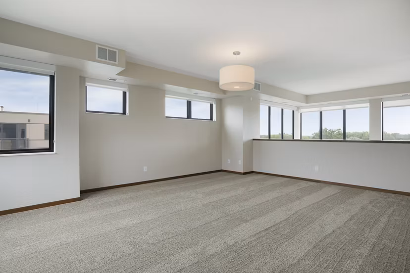 Cozy bedroom featuring plush bedding and modern decor at Ellipse on Excelsior luxury apartments