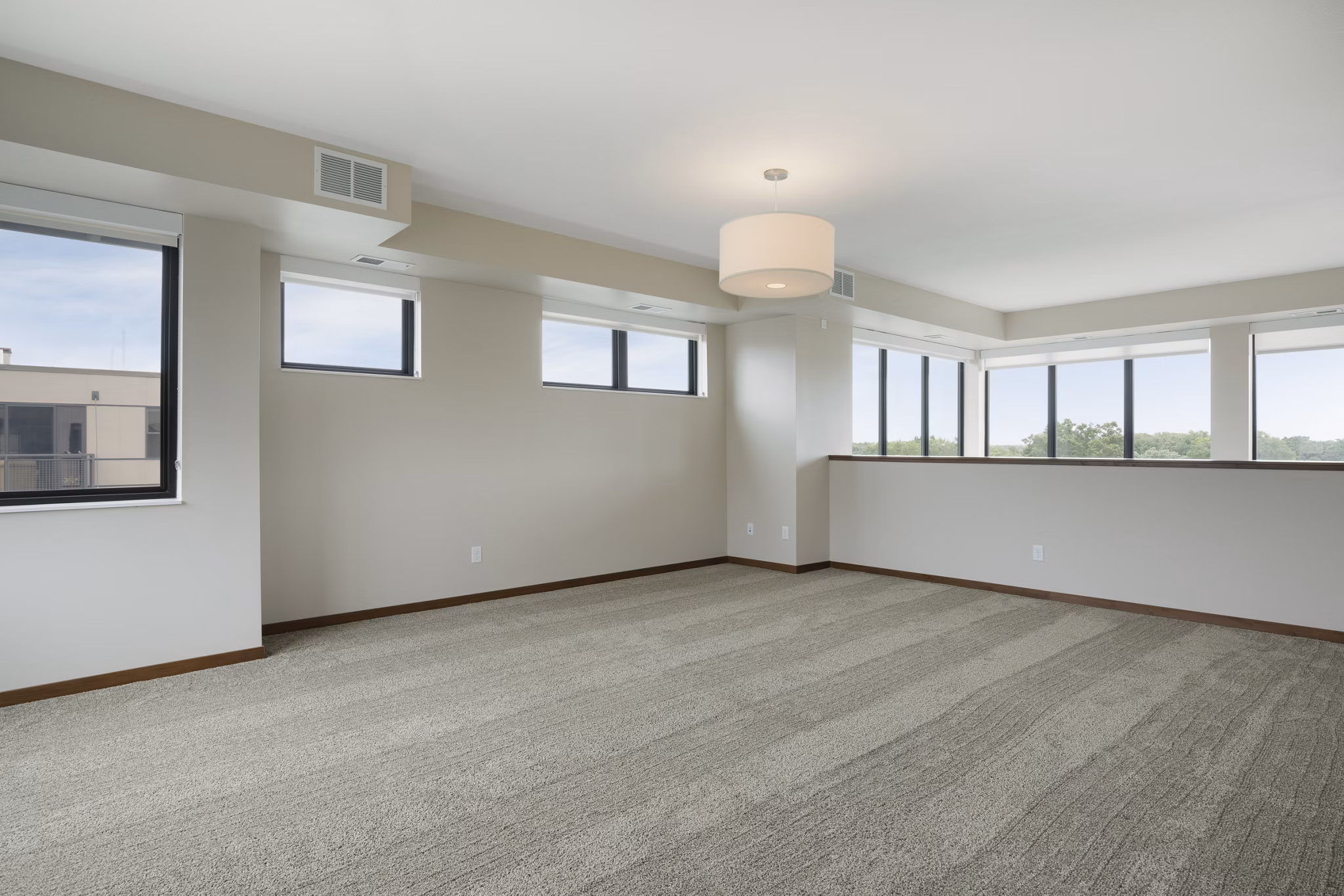 Cozy bedroom featuring plush bedding and modern decor at Ellipse on Excelsior luxury apartments