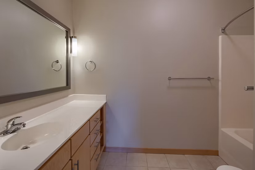 Modern bathroom with sleek fixtures and marble countertops at Ellipse on Excelsior apartments, showcasing luxury living spaces