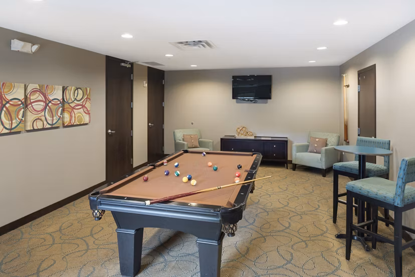 Game room with billiards and lounge seating at Ellipse on Excelsior luxury apartments