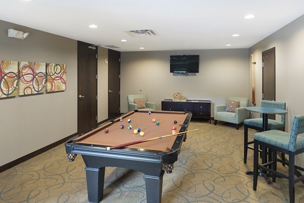 Game room with billiards and lounge seating at Ellipse on Excelsior luxury apartments