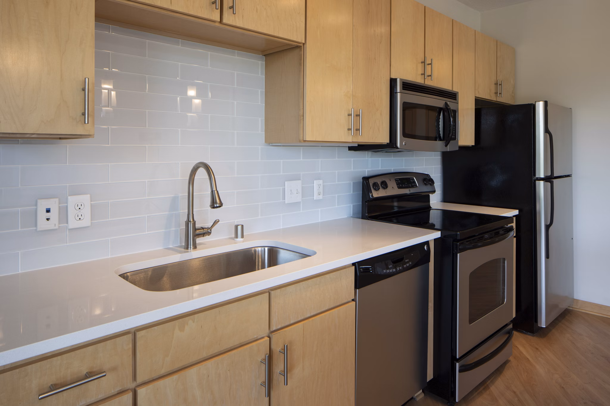 Kitchen with granite countertops and stainless steel appliances at Ellipse on Excelsior luxury apartments