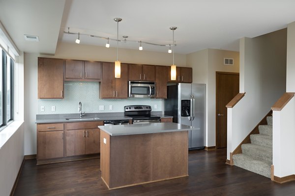 Ellipse on Excelsior: Modern kitchen with stainless steel appliances and granite countertops in luxury apartments
