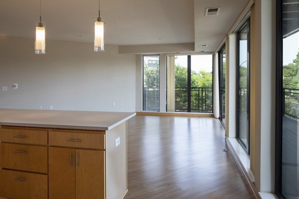 Elegant living room showcasing modern furnishings and ample natural light in Ellipse on Excelsior luxury apartments