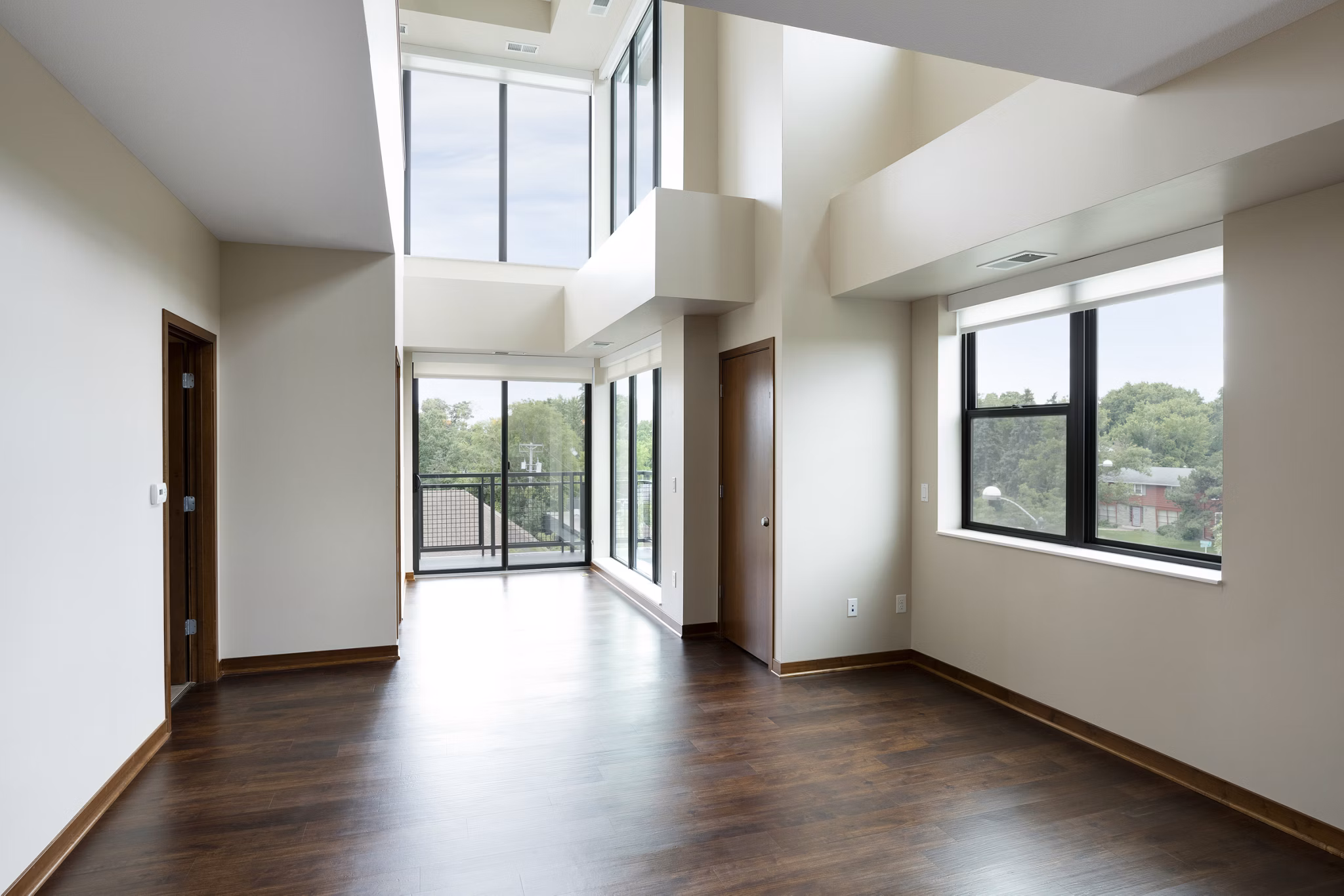 Ellipse on Excelsior: Sunlit living room with modern furnishings and stylish decor