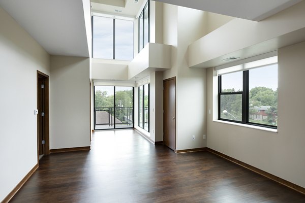 Ellipse on Excelsior: Sunlit living room with modern furnishings and stylish decor