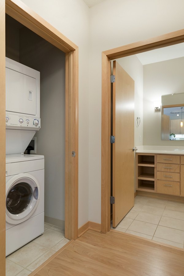 Laundry room featuring modern appliances at Ellipse on Excelsior apartments