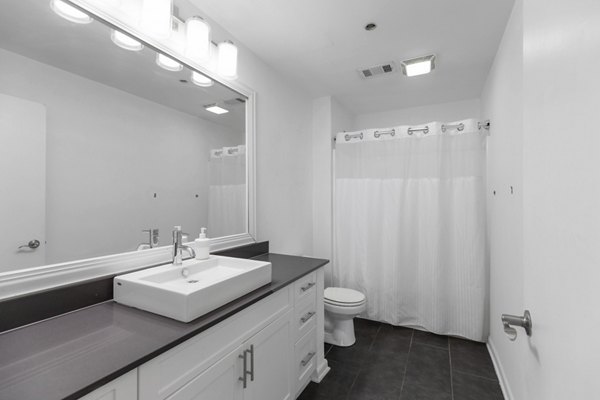 Cozy bathroom with modern fixtures at Historic Electric Building Apartments