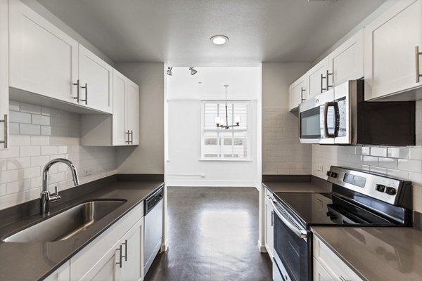 Modern kitchen with stainless steel appliances in Historic Electric Building Apartments